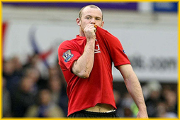 Rooney kisses badge