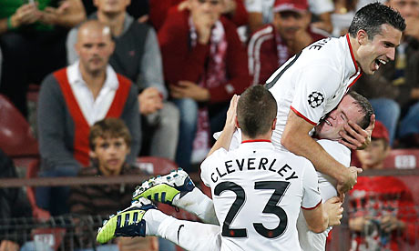 Robin van Persie celebrates with Wayne Rooney following a goal against CFR Cluj