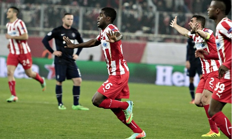 Joel Campbell, centre, celebrates scoring the second goal for Olympiakos against Manchester United